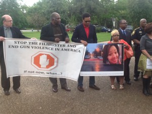 Gun reform supporters stand and rally together.