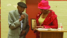 Ovide Duncantell accepts his award from President of Friends of Emancipation Park, Dorris Ellis